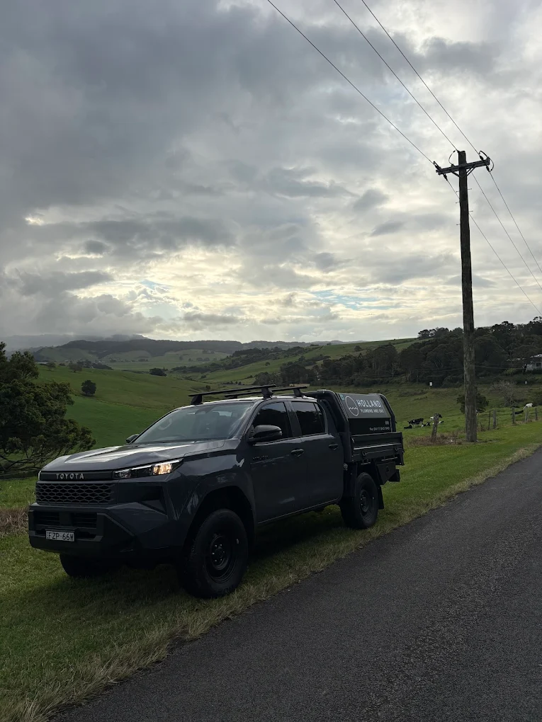 Holland Plumbing and Gas branded work ute in the Kiama South Coast hills